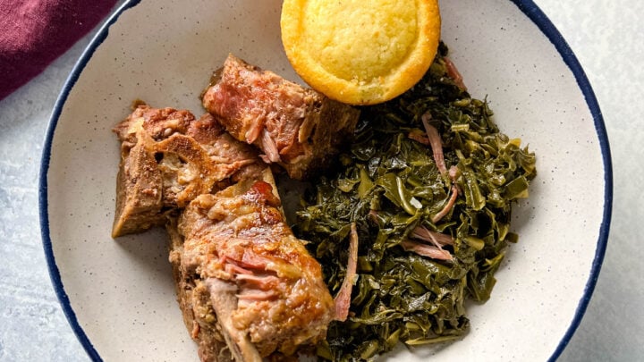 slow cooker Crockpot neck bones in a bowl with collard greens and cornbead