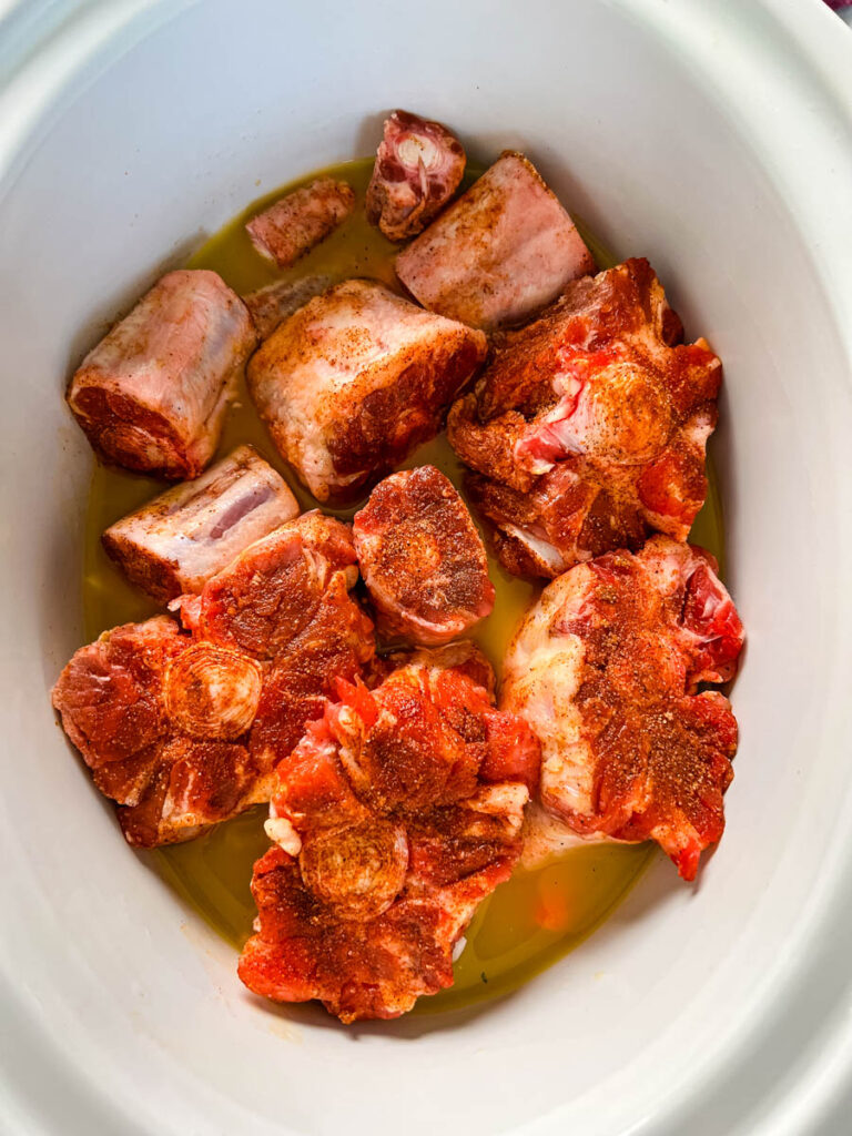 raw oxtails in a Crockpot slow cooker