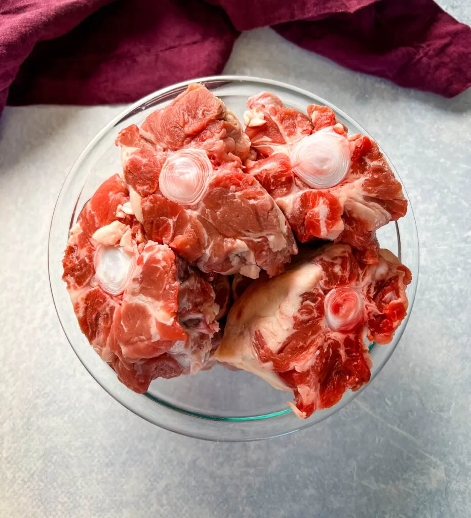 raw oxtails in a glass bowl