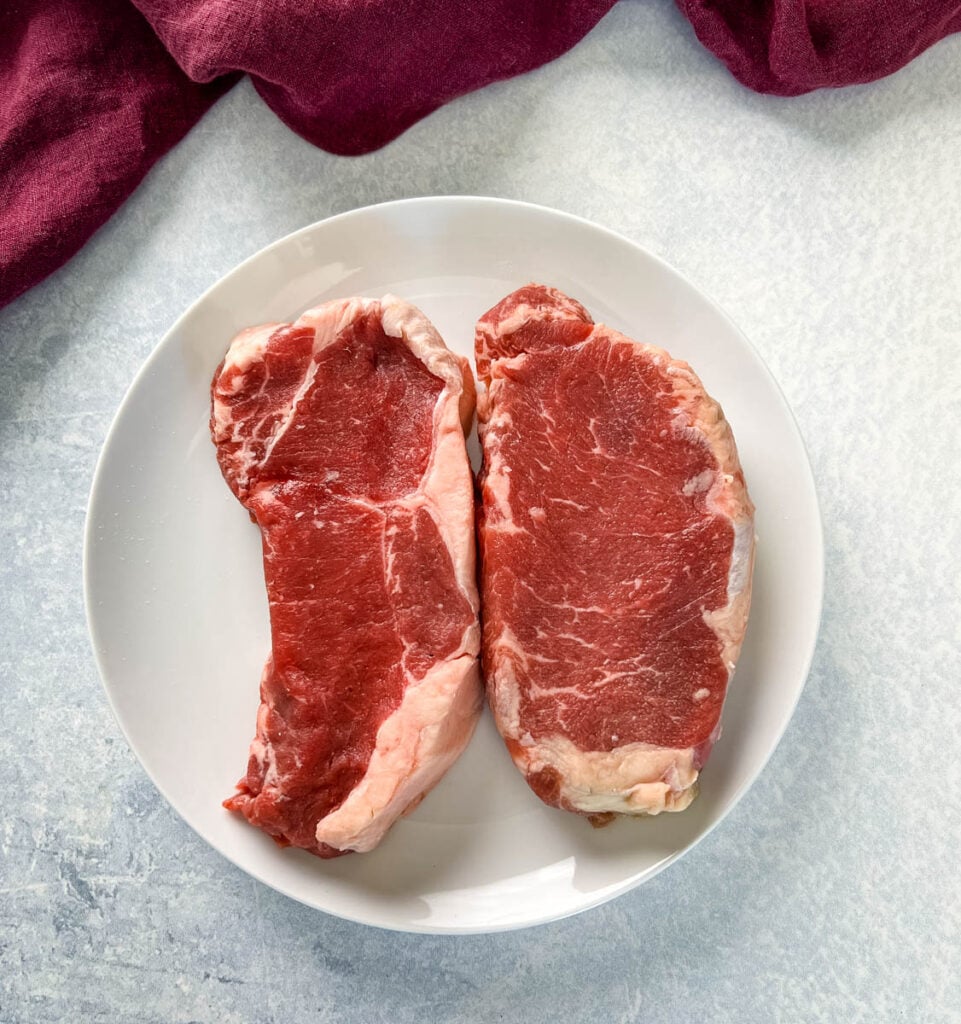 raw sirloin steaks on a plate