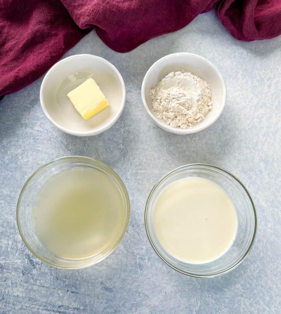 butter, flour, broth, and heavy cream in separate glass bowls