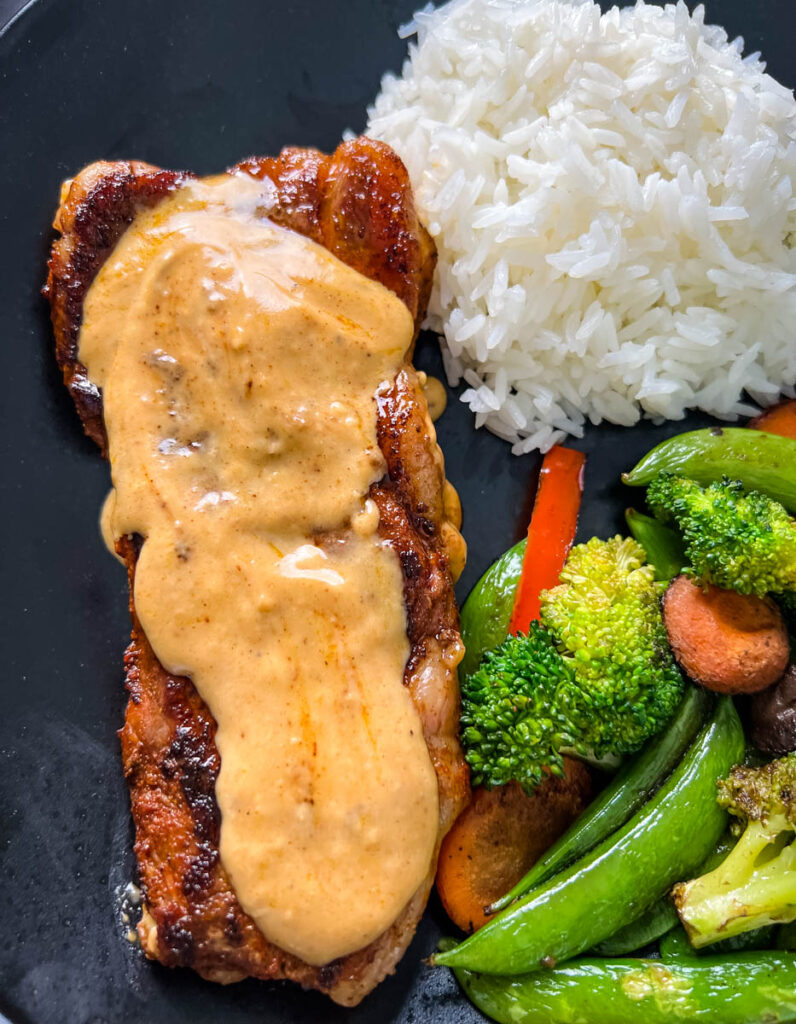smothered steak with gravy and rice and vegetables