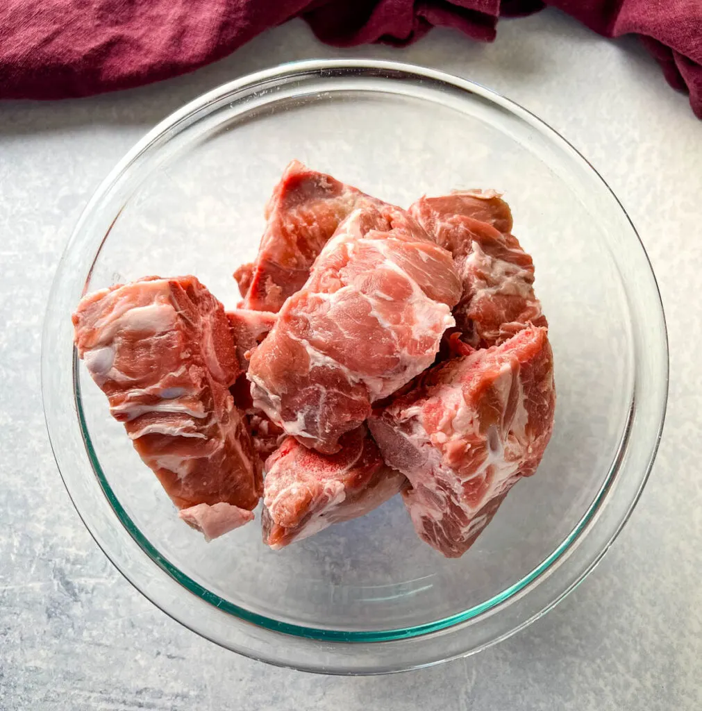 raw pork neck bones in a glass bowl