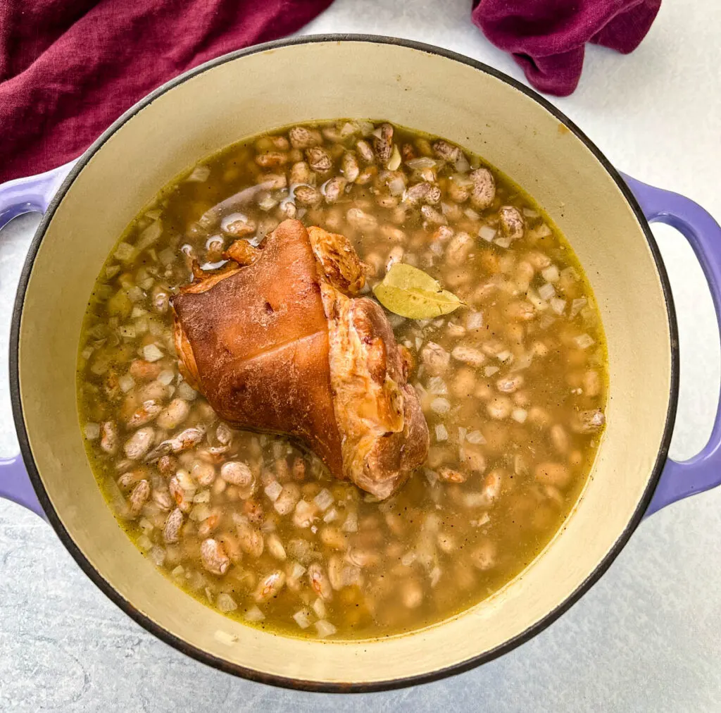 cooked pinto beans and ham hocks in a Dutch oven