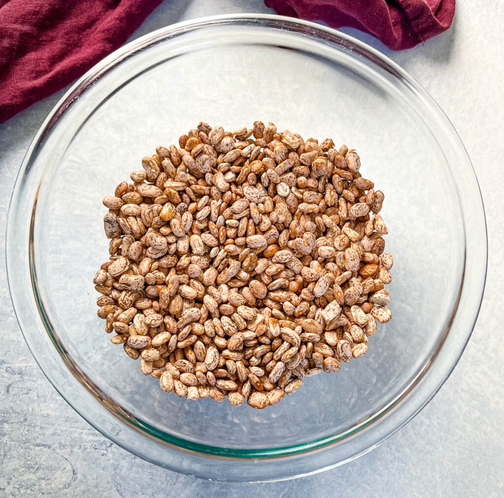 dry pinto beans in a glass bowl