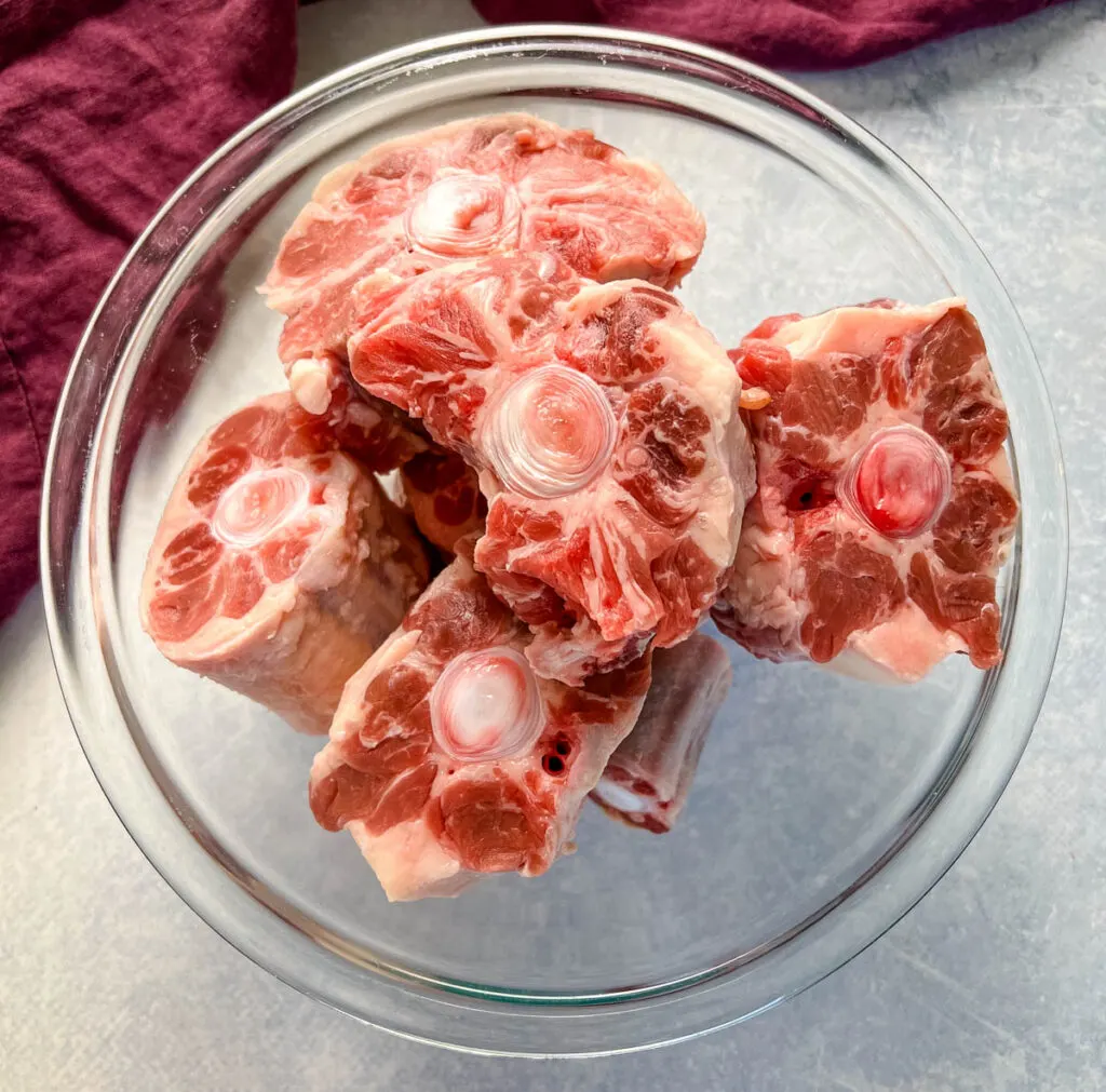raw oxtail in a glass bowl