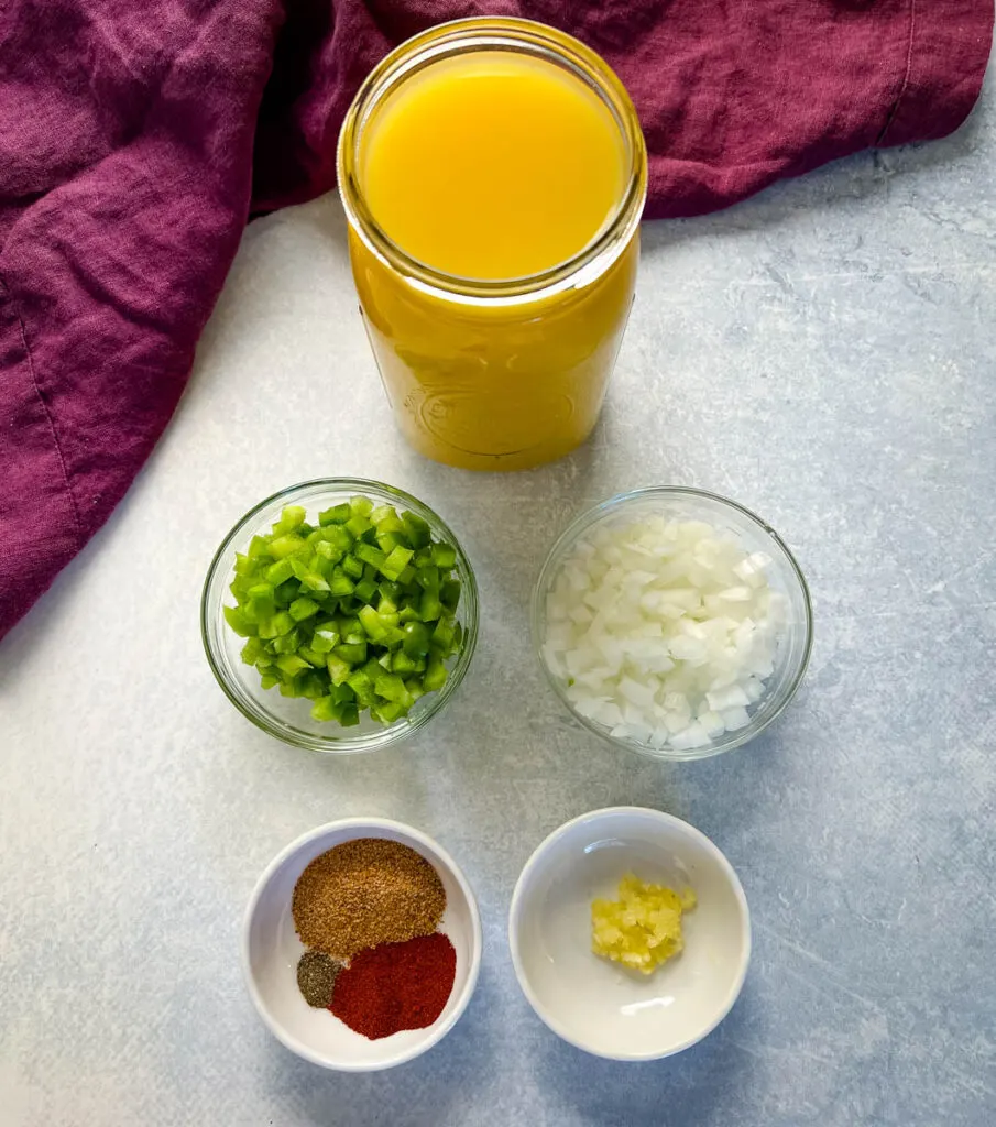 broth, green peppers, onions, spices, and garlic in separate bowls