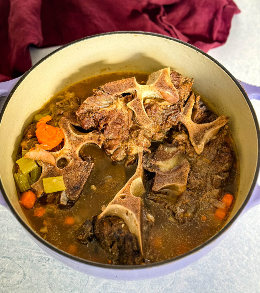 beef neck bones in a pot with vegetables