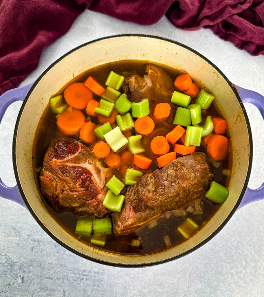 beef neck bones in a pot with vegetables