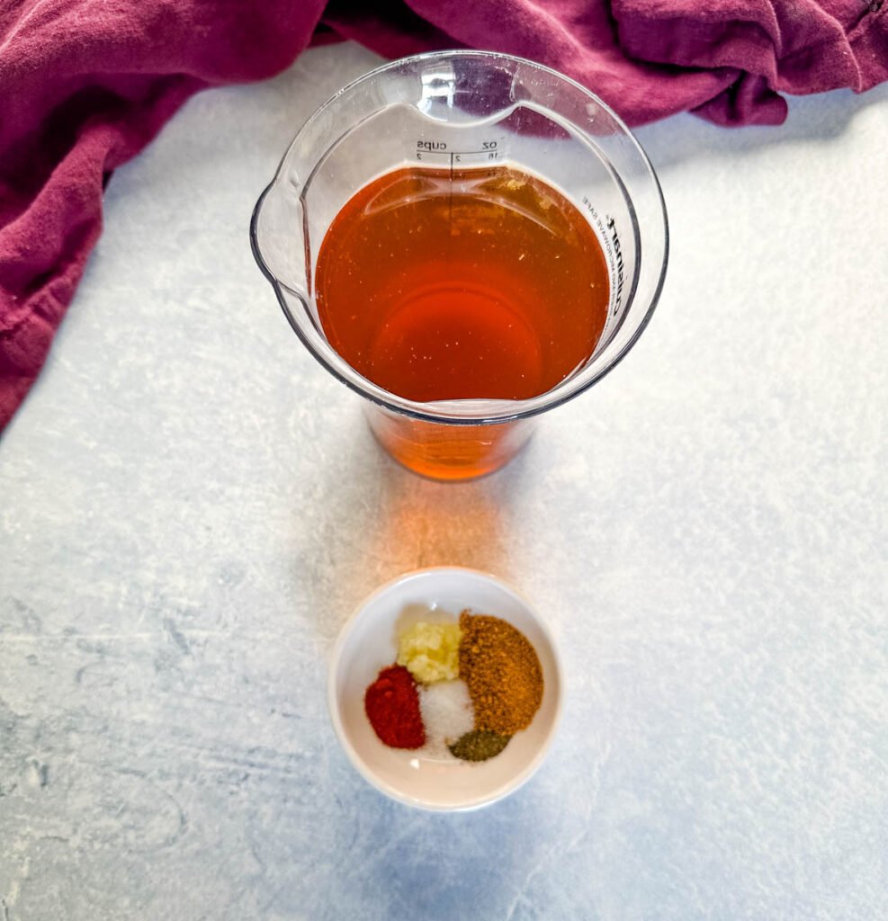 beef broth and spices in separate bowls