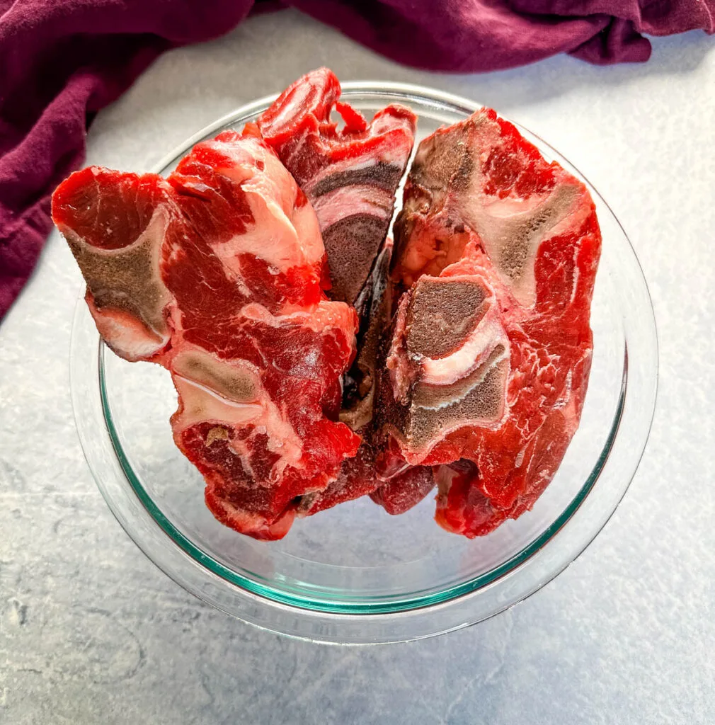 raw beef neck bones in a glass bowl