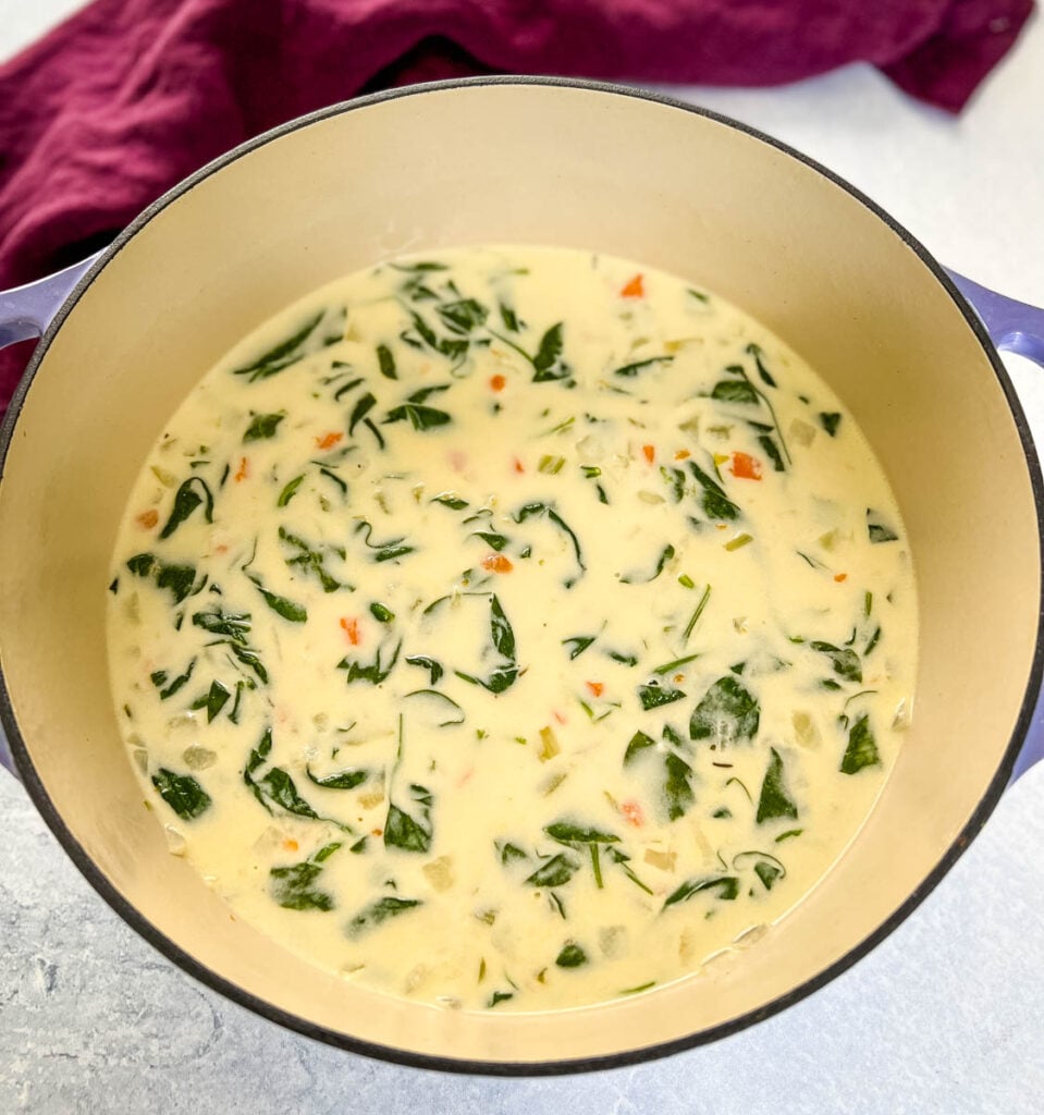 chicken florentine soup and spinach in a soup pot