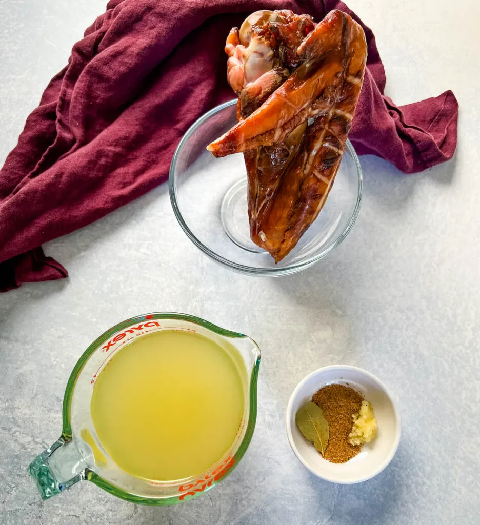 smoked turkey, broth, and spices in separate bowls