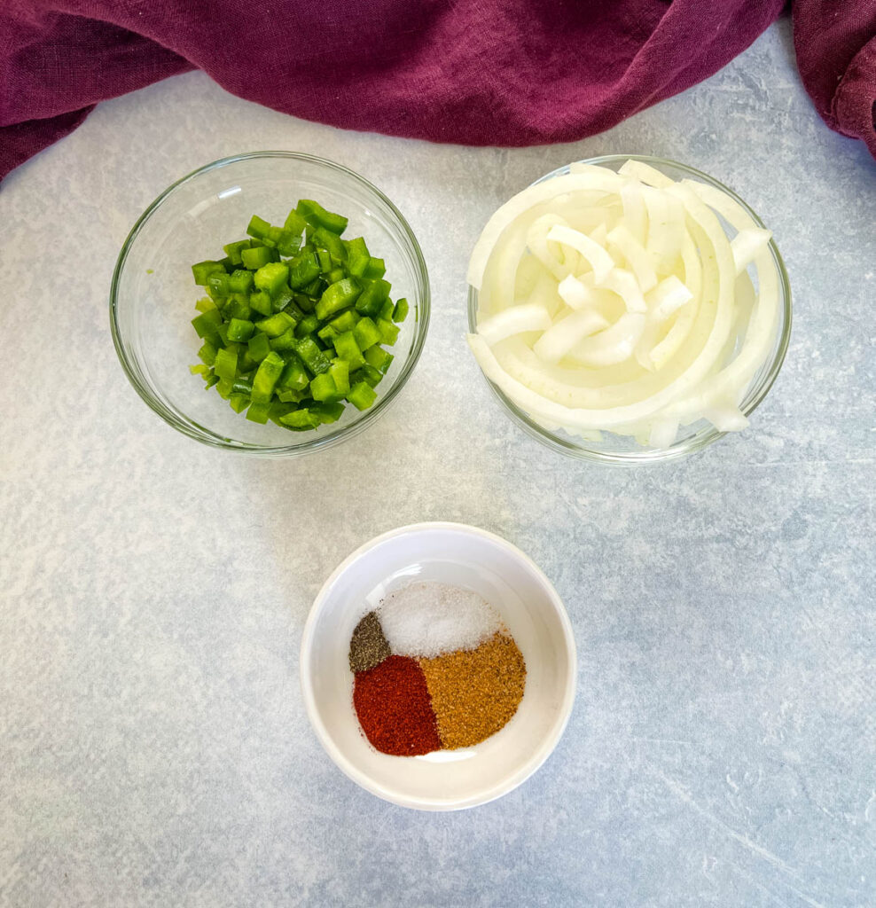 green peppers, onions, and spices in separate bowls