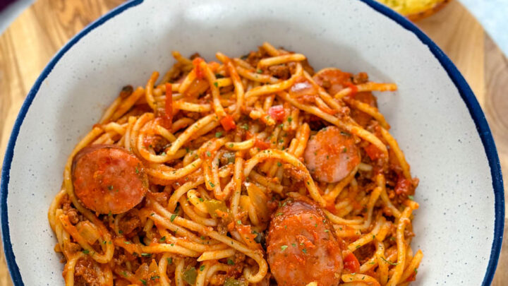 beef and sausage spaghetti in a white bowl