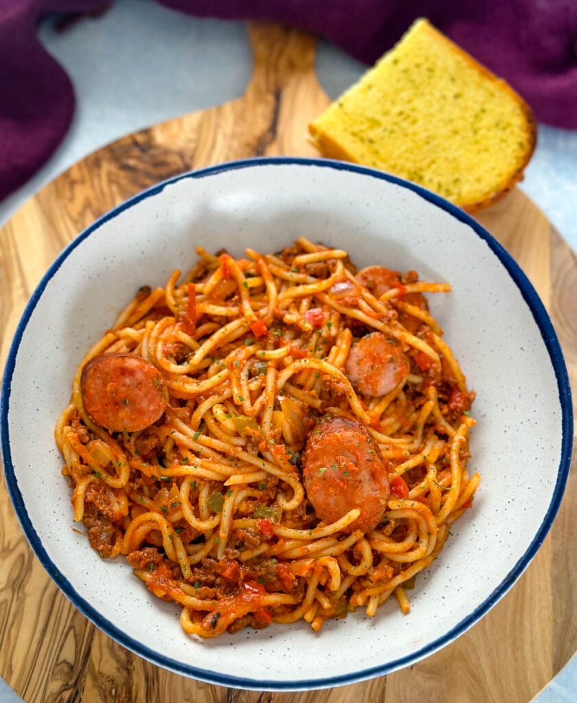 beef and sausage spaghetti in a white bowl