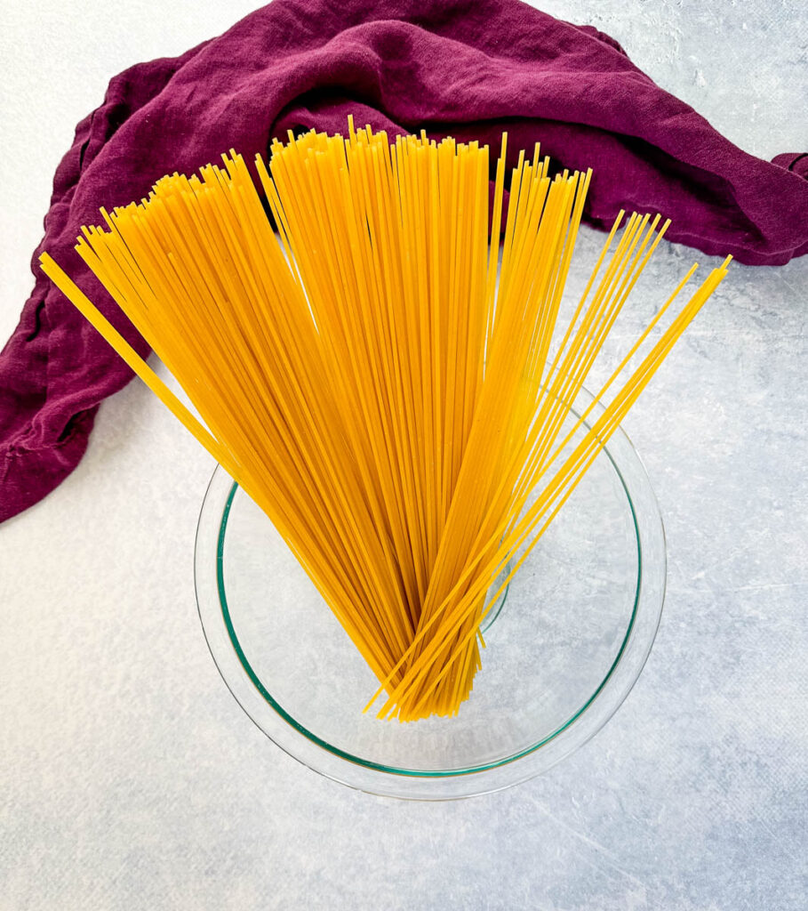dry spaghetti pasta in a glass bowl