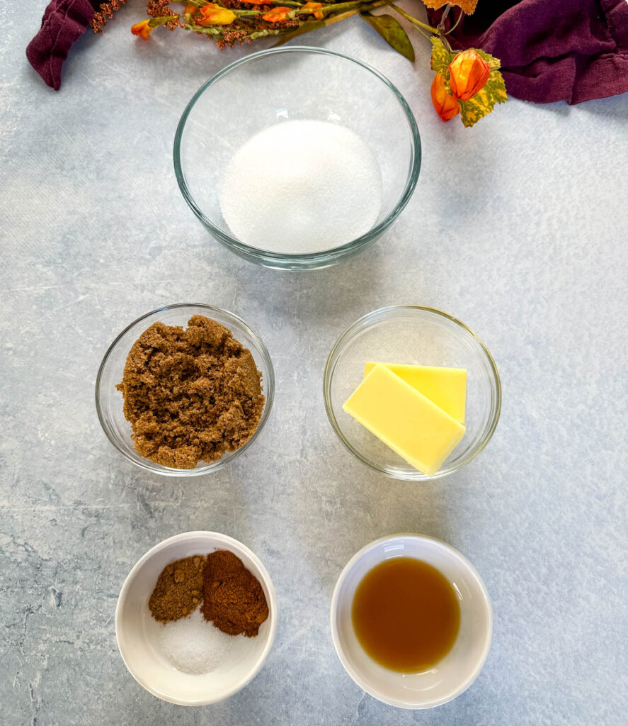 white sugar, brown sugar, butter, cinnamon, nutmeg, cloves, and vanilla in separate bowls