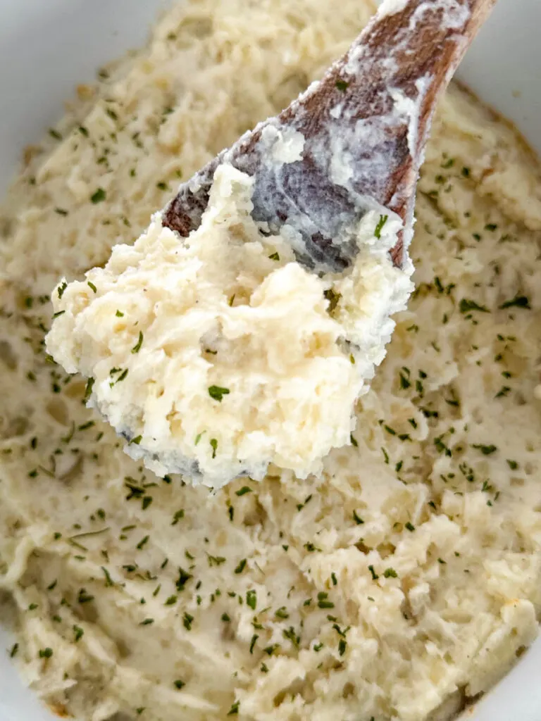 Crockpot slow cooker mashed potatoes in a wooden spoon