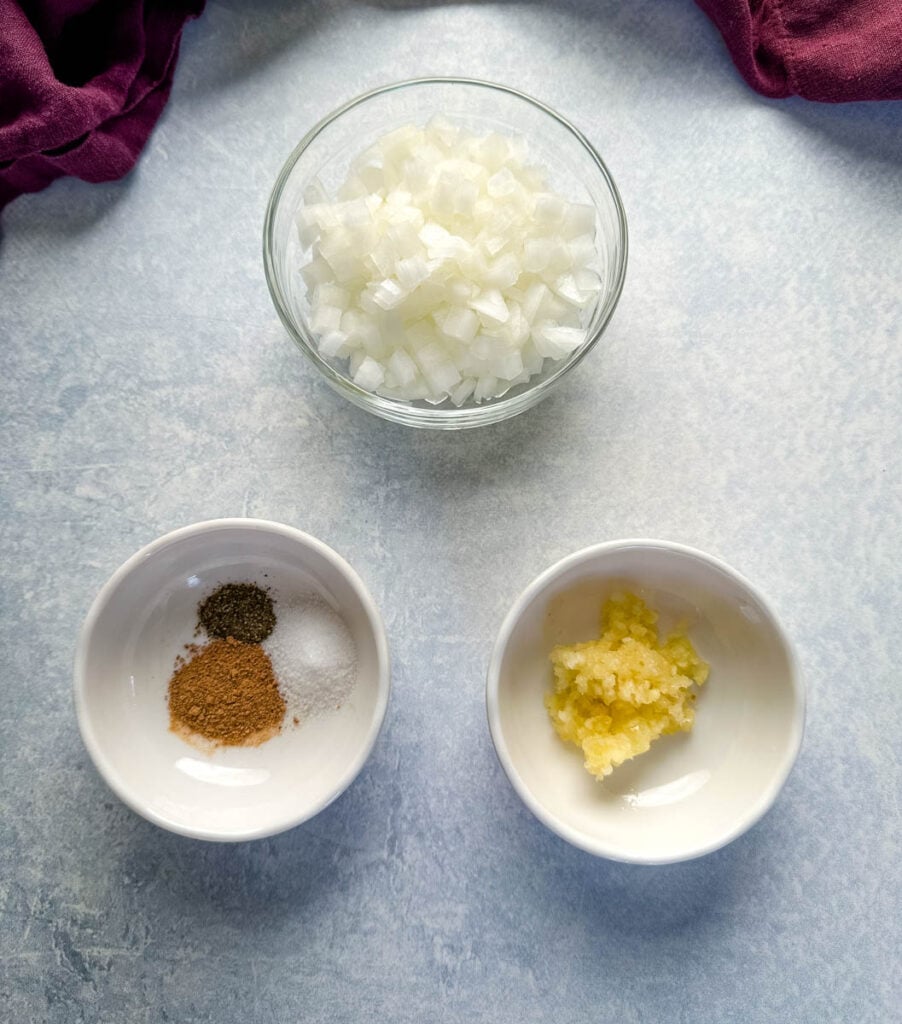 onions, garlic, and spices in separate bowls