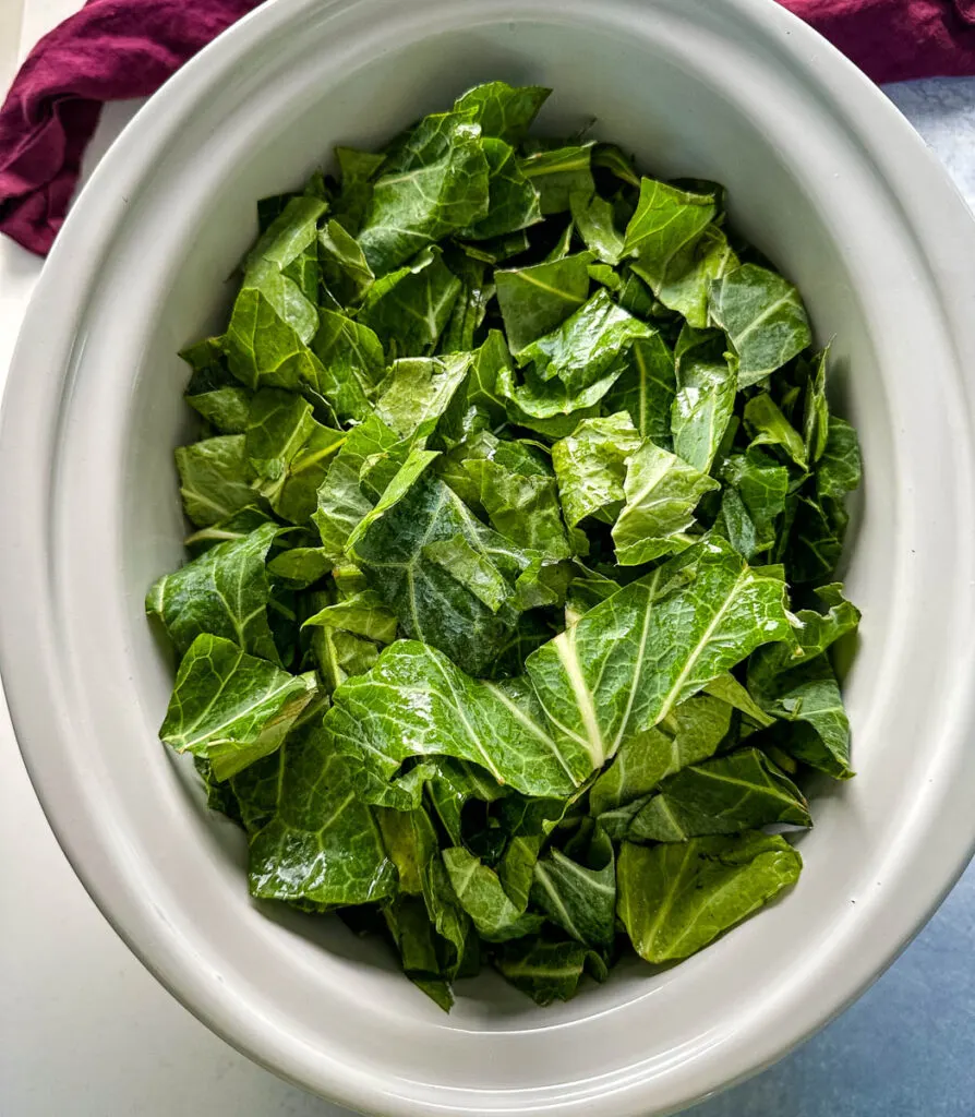 fresh collard greens in a Crockpot slow cooker