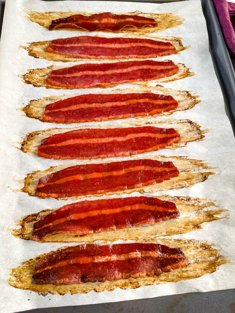 baked turkey bacon on a sheet pan with parchment paper