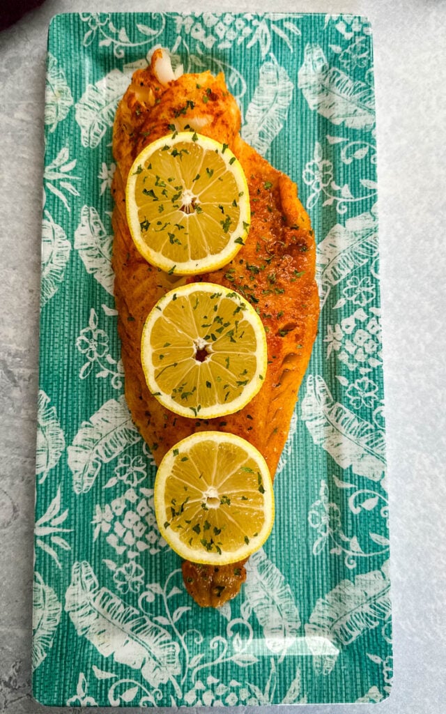 grilled cod with lemon on a plate