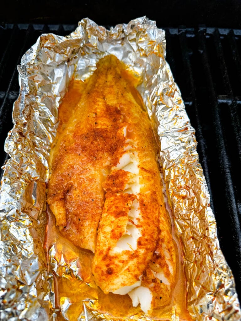 seasoned cod in foil on a grill