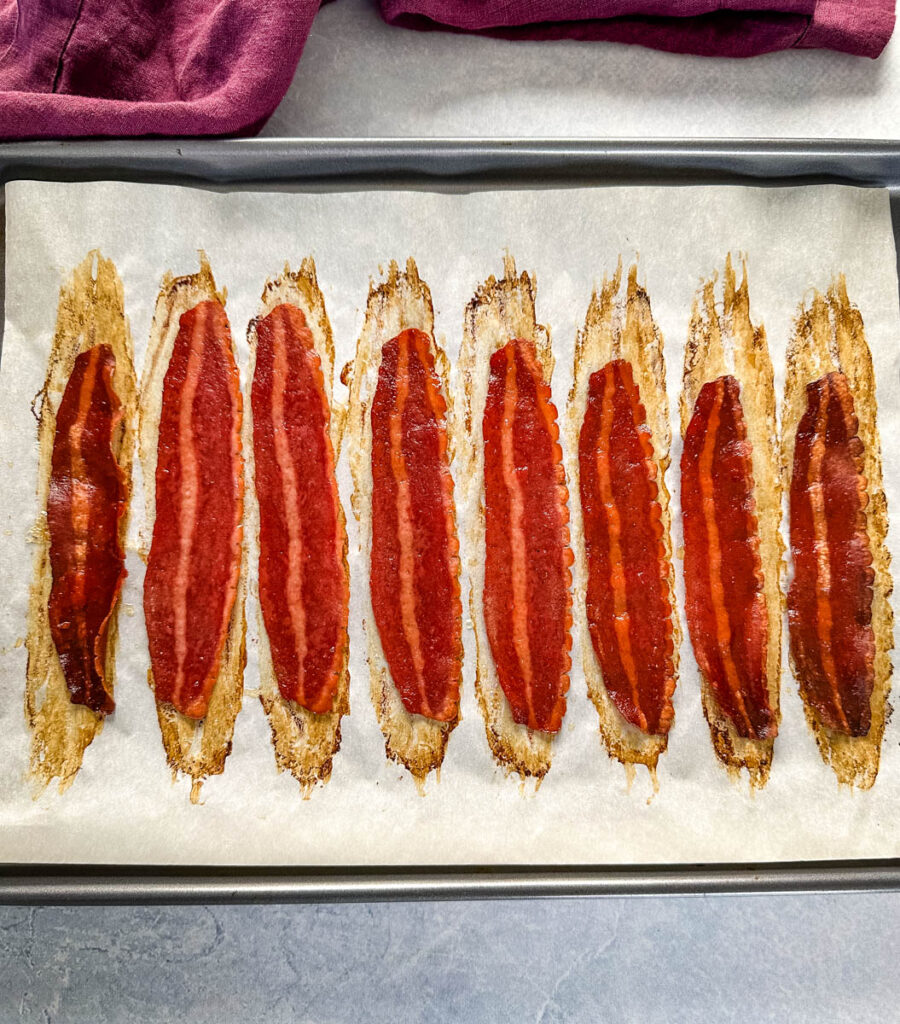 baked turkey bacon on a sheet pan with parchment paper