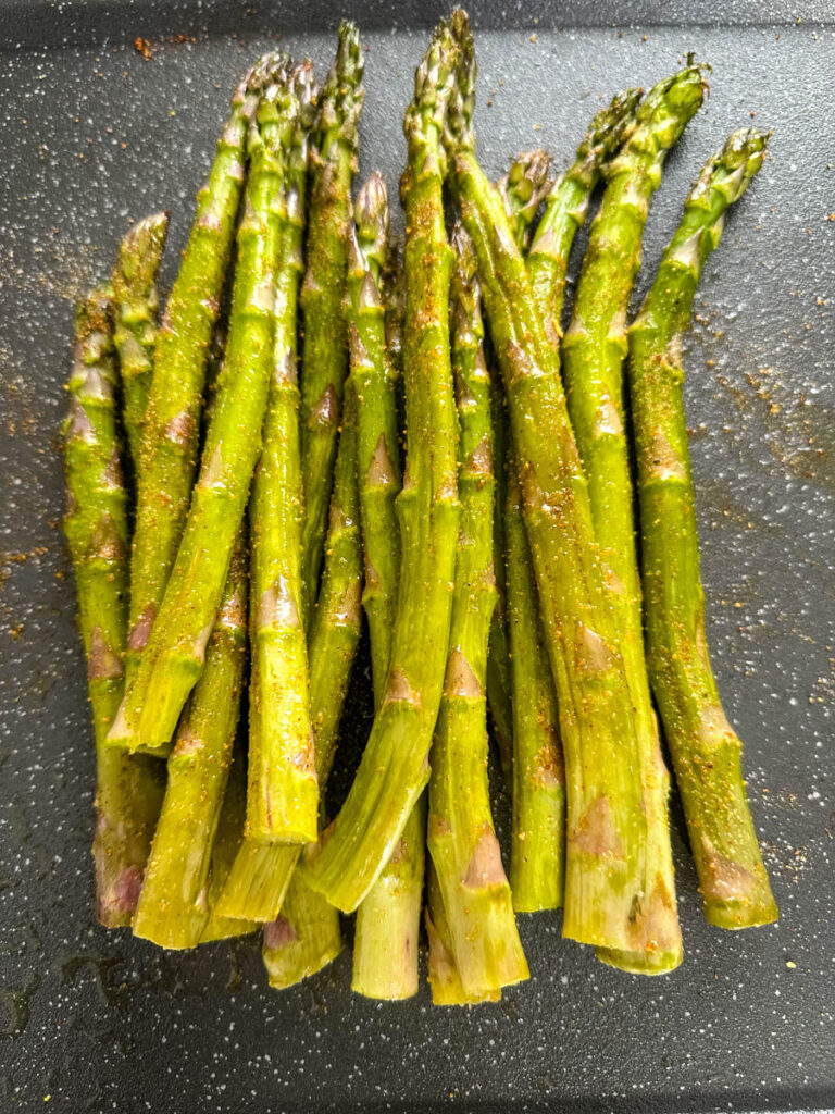 fresh asparagus with spices on a plate
