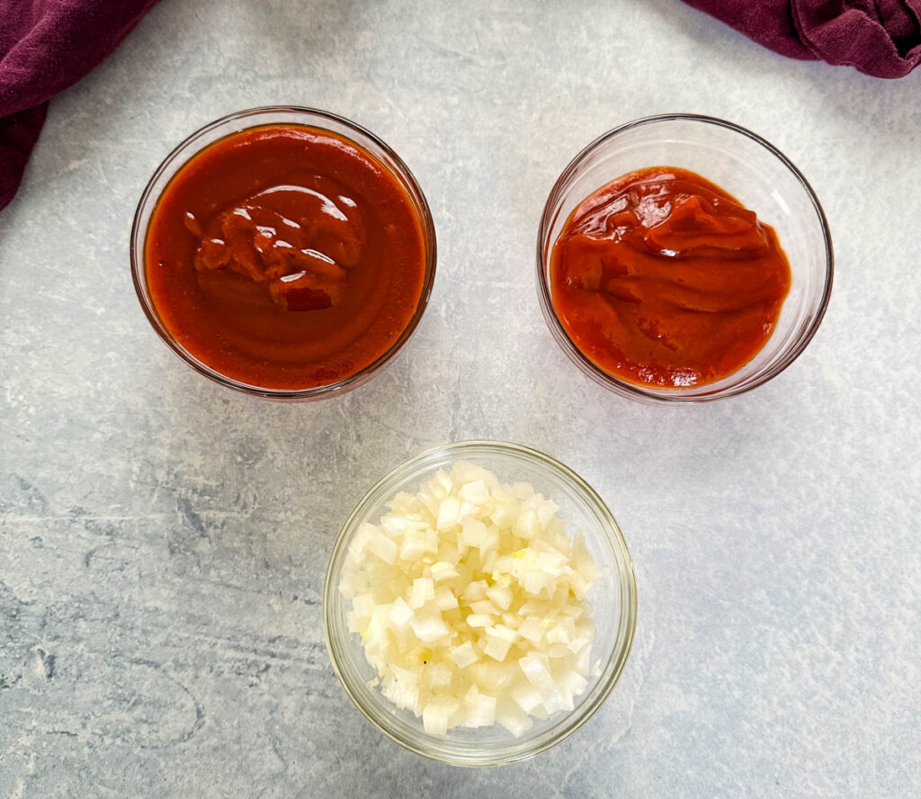 bbq sauce, ketchup, and chopped white onions in separate bowls