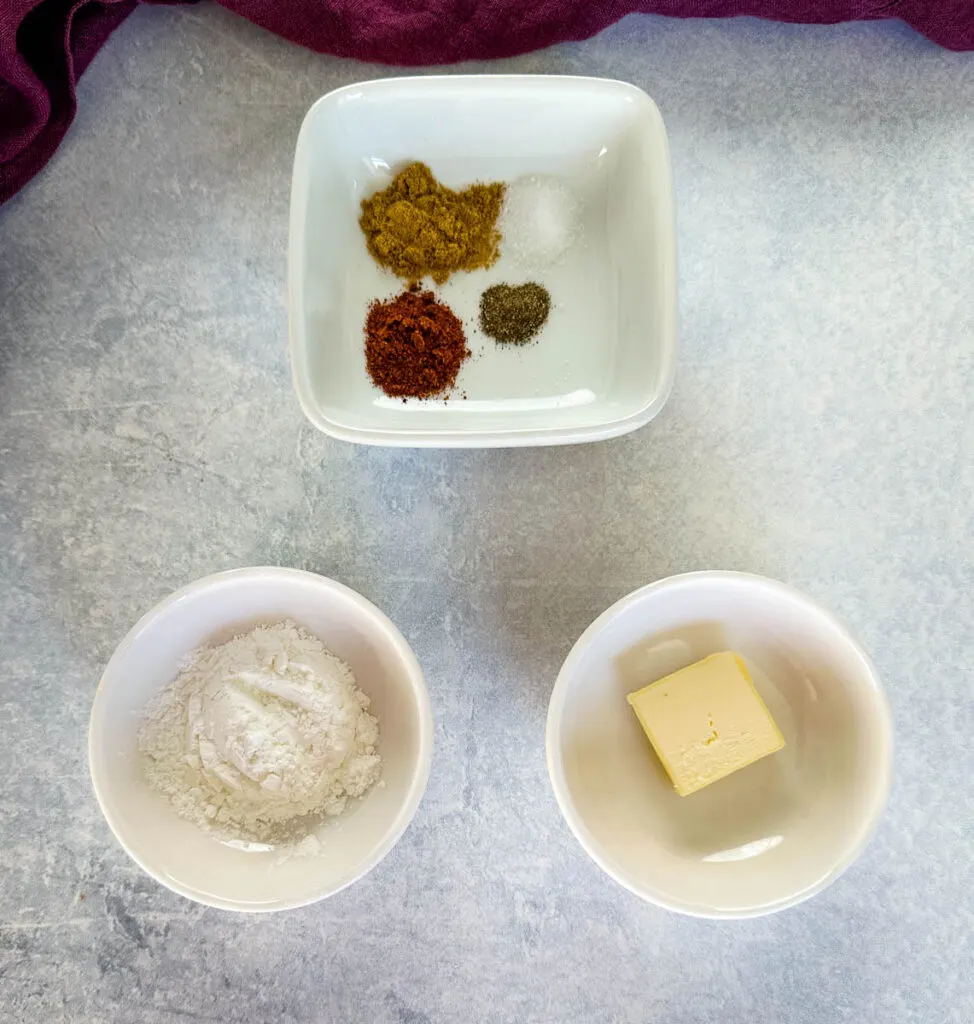 spices, butter, and flour in separate white bowls