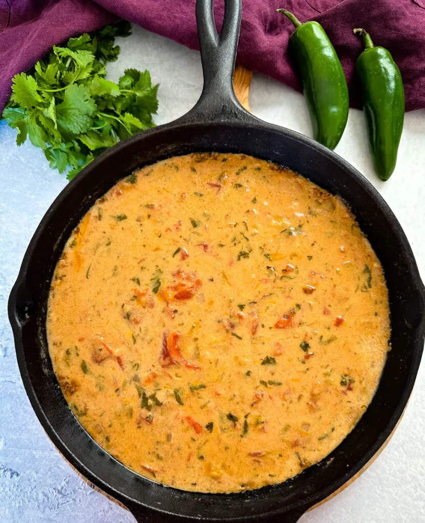 smoked queso cheese dip in a cast iron skillet