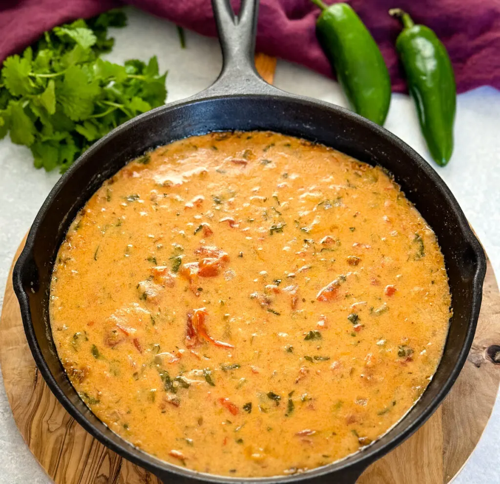 smoked queso cheese dip in a cast iron skillet