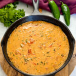 smoked queso cheese dip in a cast iron skillet