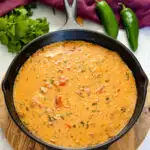 smoked queso cheese dip in a cast iron skillet