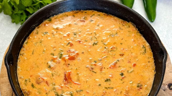 smoked queso cheese dip in a cast iron skillet