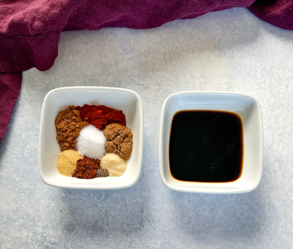 homemade steak rub spices and soy sauce in separate white bowls