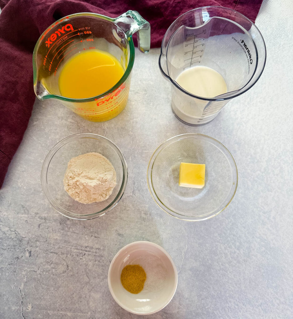 broth, heavy cream, flour, butter, and spices in separate bowls