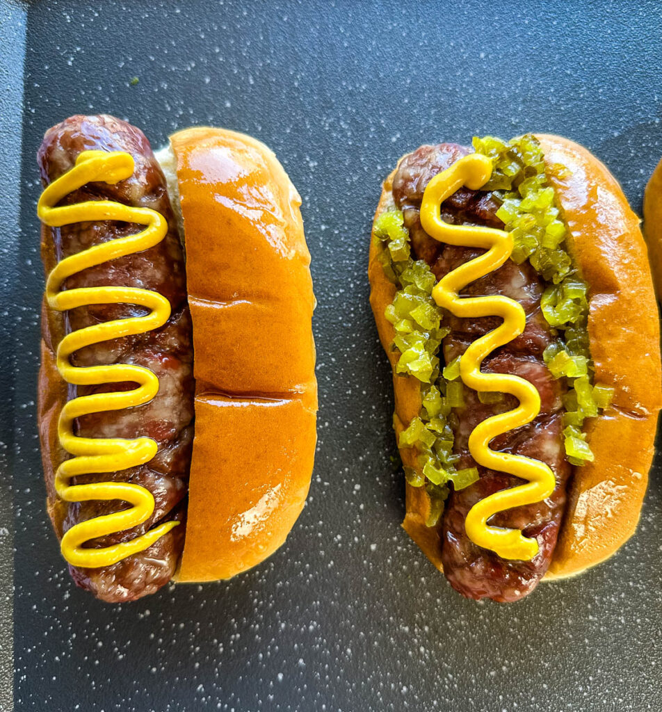 smoked brats on buns with mustard and relish