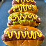 smoked brats on buns with mustard and relish