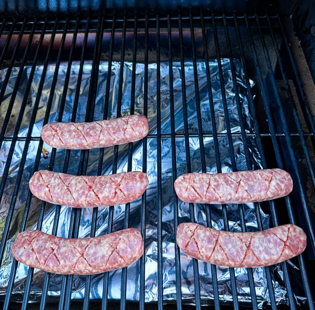 uncooked brat on Traeger smoker grill