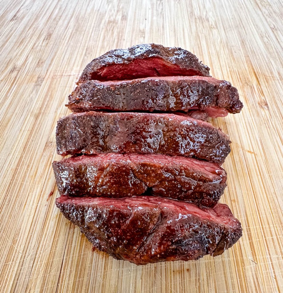 sliced smoked filet mignon on a cutting board