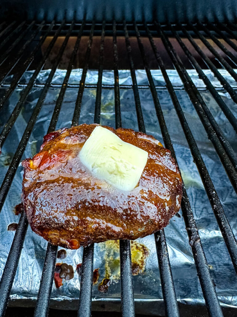 smoked filet mignon with butter on a Traeger grill