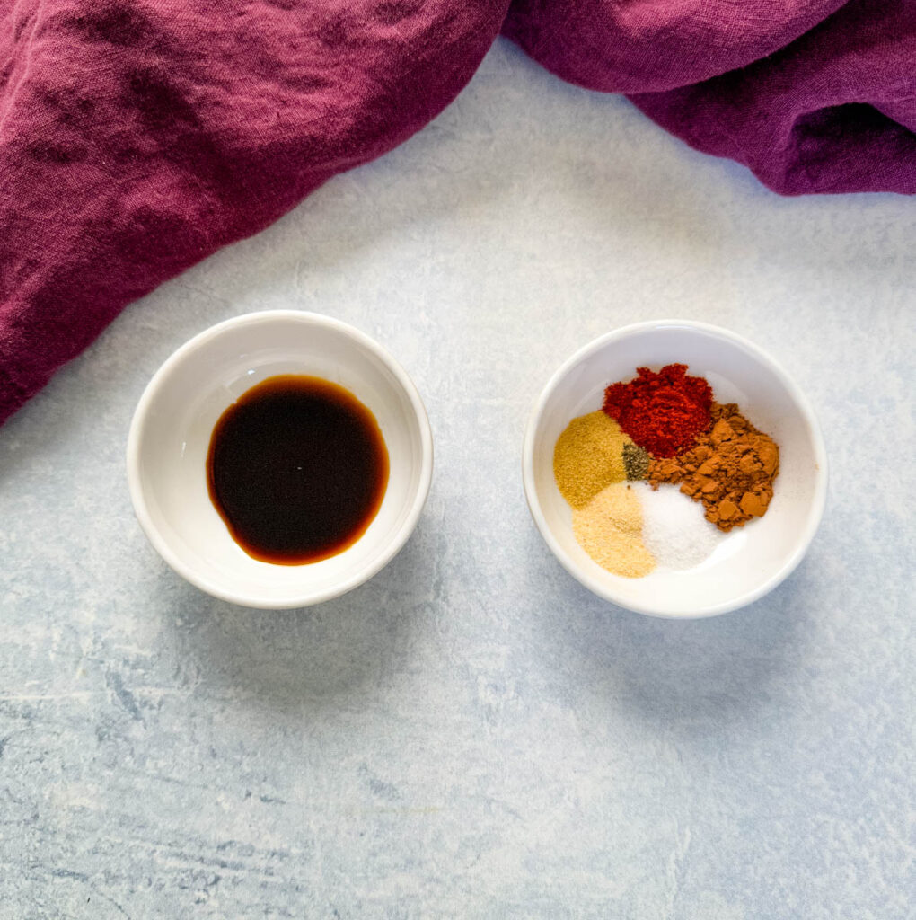 steak rub spices and soy sauce in separate white bowls