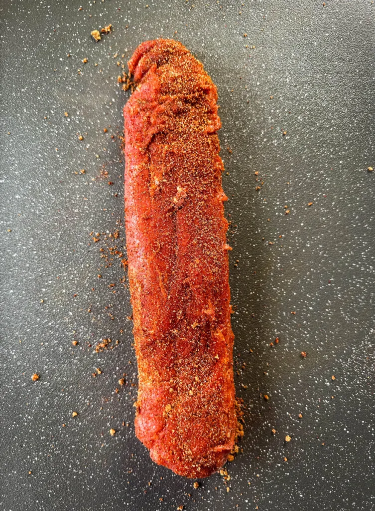 seasoned pork tenderloin on a flat surface