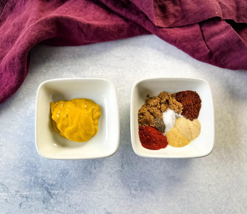 yellow mustard and spices in separate white bowls