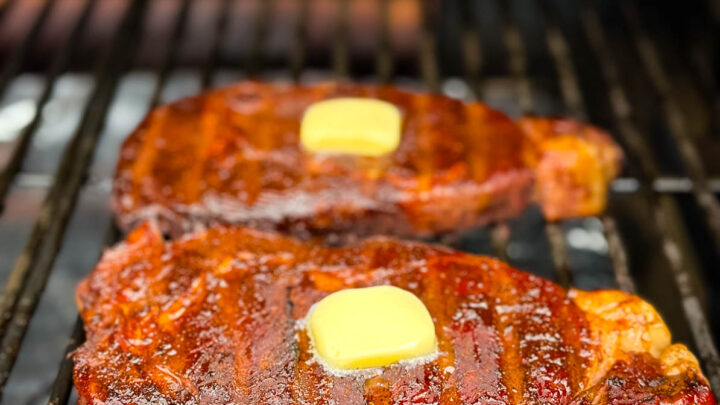 smoked ribeyes with butter on a Traeger smoker grill