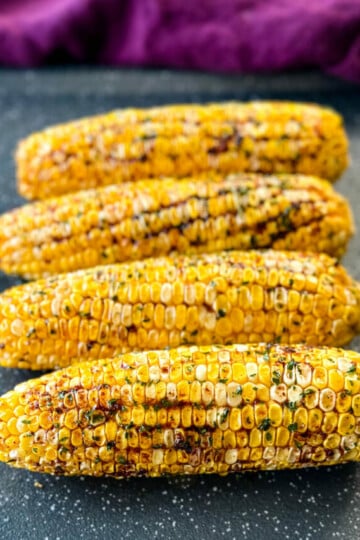Traeger smoked corn on the cob with garlic butter on a sheet pan