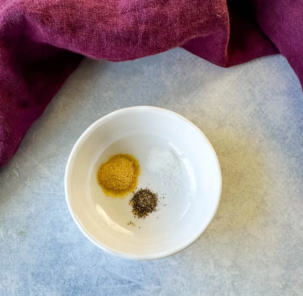 onion powder, salt, and pepper in a small white bowl